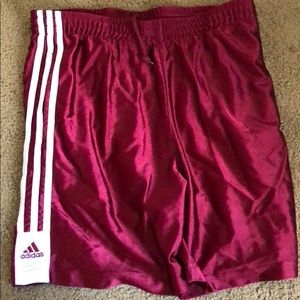 Some maroon adidas shorts